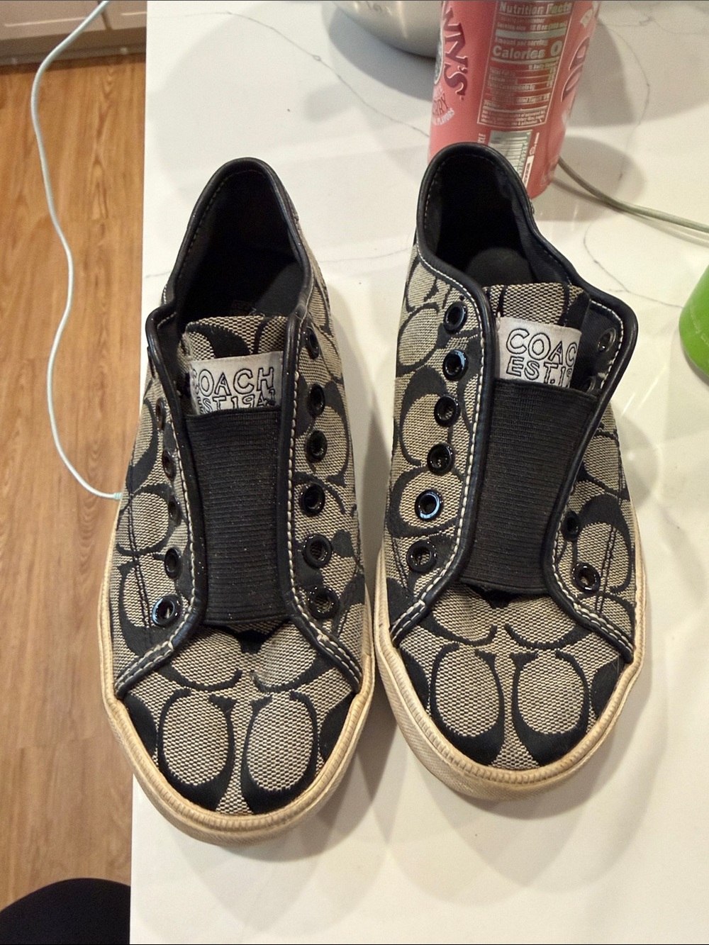 Coach women’s Slip-On Logo Sneakers in Black/Tan